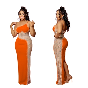 Détail de robe longue orange à une épaule avec ornements en strass et fente latérale