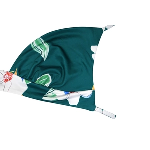 Detailed view of tropical floral print fabric with tie-up straps for a summer dress