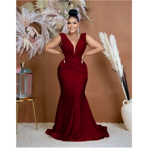 Close-up of deep red satin V-neck dress showing waist pleats and smooth fabric texture