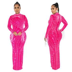 Close-up of pink mesh dress with wavy rhinestone patterns and fringe tassel sleeves