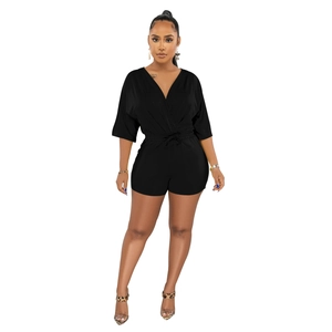Detailed view of women's black V-neck romper featuring a drawstring waist and midi sleeves