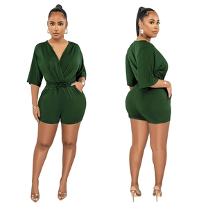 Front and back view of a dark green V-neck romper with elastic waist and side pockets