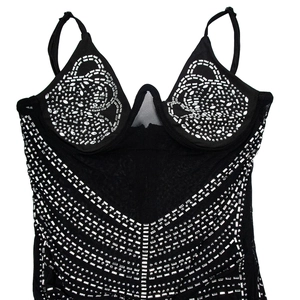 Detailed macro view of black mesh bustier with sparkling silver rhinestones and thin straps