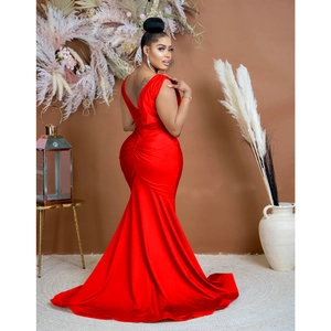 Macro detail of the back view of a red satin V-neck mermaid dress with elegant pleated fabric