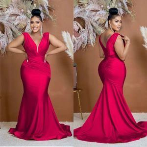 Detail of red V-neck sleeveless satin evening dress with elegant waist pleats and fishtail hem