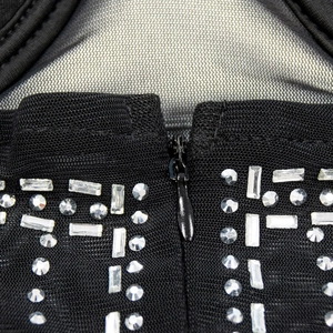 Detailed macro view of black mesh dress featuring invisible zipper and crystal rhinestone beads