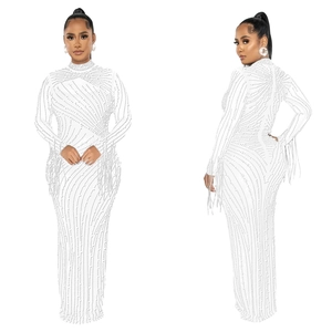 Close-up of white high neck dress with beaded patterns and fringe details on the sleeves
