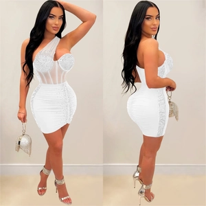 Detail of white one-shoulder mini dress featuring mesh patchwork and crystal rhinestones