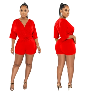 Detail view of red V-neck romper with batwing sleeves and adjustable drawstring waist