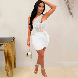 Detail of white one-shoulder mini dress with rhinestone mesh corset and elegant accessories