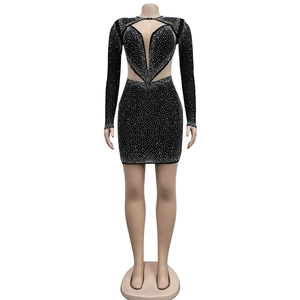 Detail of black mini dress with mesh cutouts and shimmering rhinestones decoration