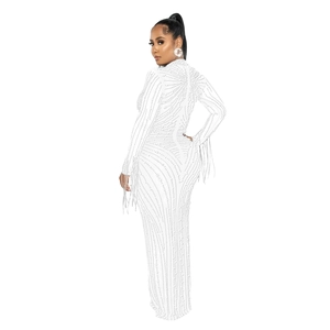 Detailed close-up of white evening dress with rhinestones and elegant fringe sleeves