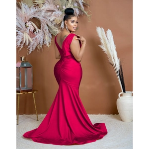 Detail view of the deep rose red mermaid evening dress showing back ruching and silk texture