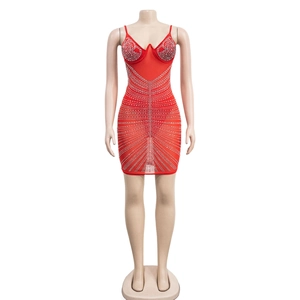 Detail of red mesh mini dress with sparkling silver rhinestones on a mannequin