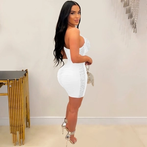 Detail view of white mini bodycon dress with silver rhinestones on elastic mesh fabric