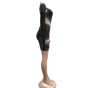 Detail of black rhinestone mini dress with mesh cutout and sparkling silver embellishments
