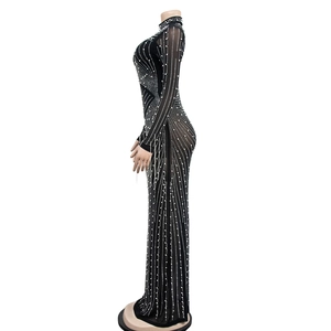 Detail of semi-sheer mesh evening dress with shimmering rhinestones on black fabric