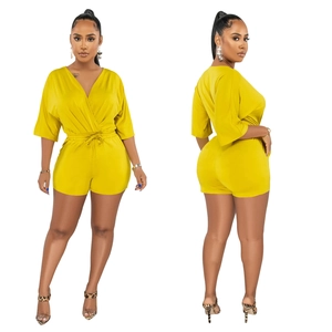 Front and side view of a bright yellow V-neck short romper with adjustable drawstring waist