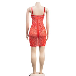 Close-up of red bodycon dress featuring rhinestone patterns and back zipper detail
