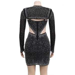 Close-up of the back cutout detail and mesh fabric with rhinestones on black dress
