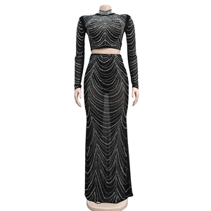 Détail d'une robe deux pièces en mesh noir avec ornements étincelants en strass ondulés