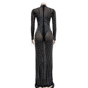 Detail of black mesh long dress featuring intricate white faux pearl and rhinestone beadwork