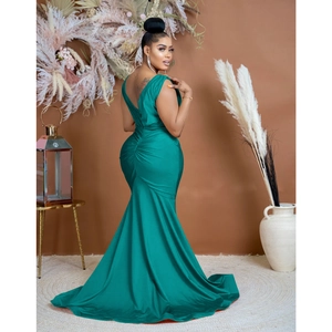 Detail of ruched hip design and back V-neck on a dark green mermaid evening gown