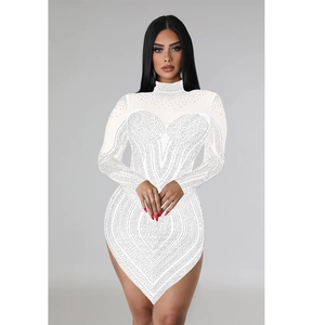 Detail of white bodycon dress with rhinestone heart pattern and asymmetric hemline