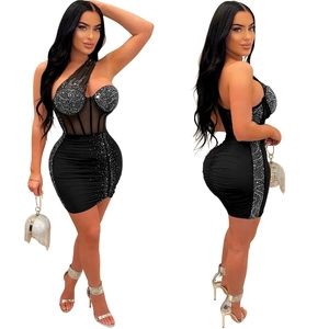 Detail of black one-shoulder mini dress with sparkling rhinestones and mesh panels