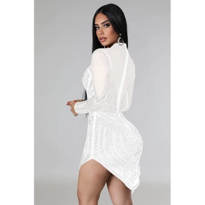 Close-up of white mesh dress with sparkly rhinestones and elegant side slit detail