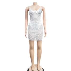 Detail of white mesh mini dress featuring silver rhinestones in a sunburst pattern