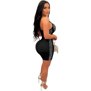 Detail of a black bodycon dress featuring shimmering rhinestones and mesh fabric