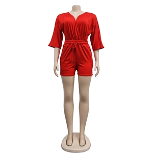 Detail view of red V-neck romper featuring a drawstring waist and soft jersey fabric