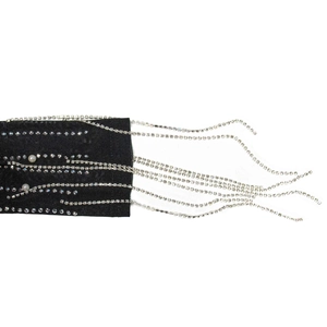 Macro shot of silver rhinestone fringe and white pearls on black mesh dress fabric