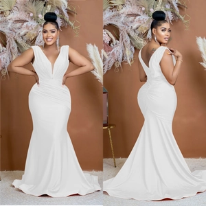 Detail view of white V-neck mermaid gown showing silk-like texture and ruched draping design