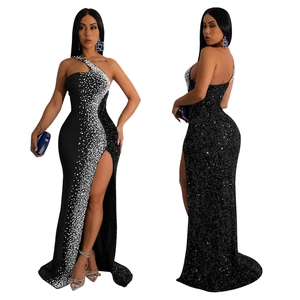 Detail of elegant black sequin evening gown featuring asymmetric shoulder and high slit