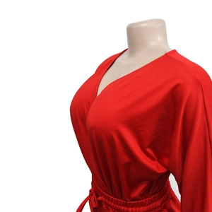 Detail view of red V-neck romper featuring a drawstring waist and loose sleeves