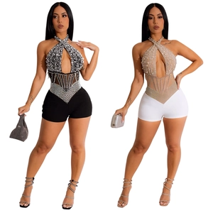 Detail of mesh bodice with rhinestones and pearl embellishments on sexy romper