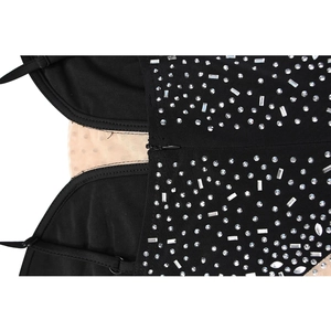 Close-up of black dress featuring silver rhinestones and nude mesh fabric detail