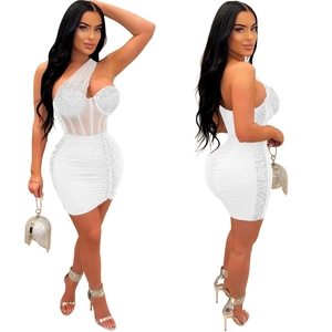 Detail of white one-shoulder mini dress with sparkling rhinestones and mesh inserts