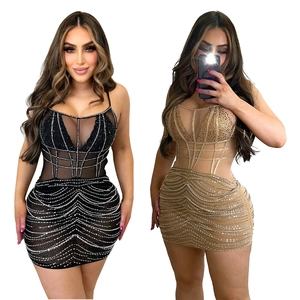 Detail of corset-style mesh mini dress with rhinestones in black and champagne
