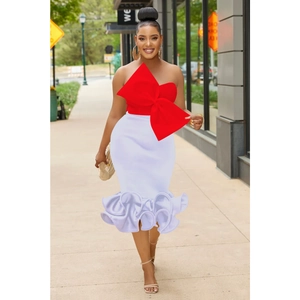 Detail of red oversized bow tube top and white fitted mermaid skirt with ruffled hemline