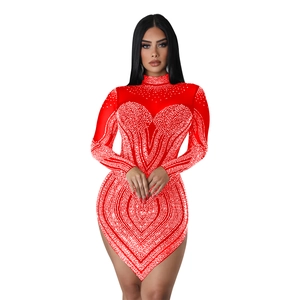 Detailed view of red bodycon dress featuring sparkling rhinestones and heart patterns