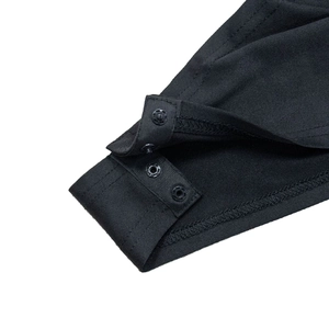 Detail of black cotton bodysuit bottom with double snap buttons and reinforced stitching