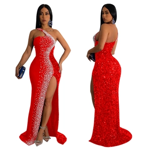 Detail of red one-shoulder evening dress featuring shimmering silver sequins and high slit