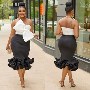 Women's chic two-piece set featuring white bow bandeau top and black fishtail skirt