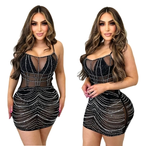 Detailed close-up of a black bodycon dress with sheer mesh and silver rhinestones