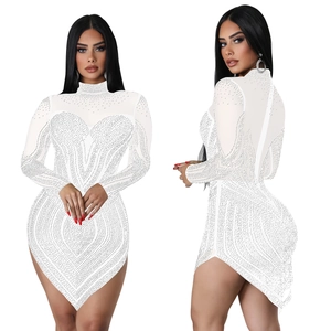 Detail of white mesh dress with silver rhinestones and irregular hemline