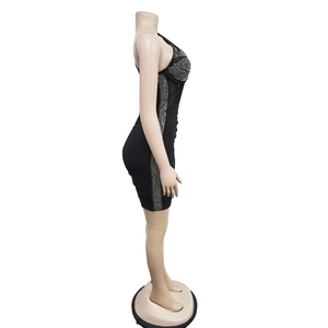 Detail view of black bodycon dress with silver rhinestones and sheer mesh side paneling