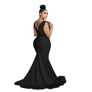Close-up of black backless evening dress featuring ruched details and a mermaid tail hem